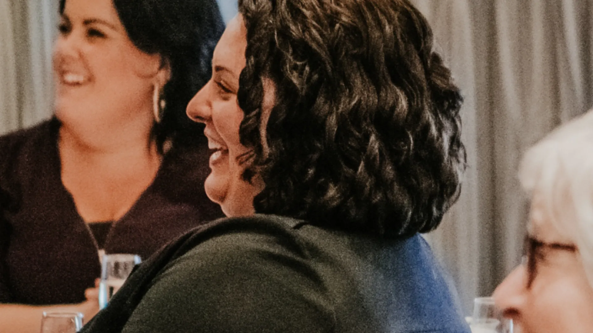 Women laughing together in a photograph from Carla's About page
